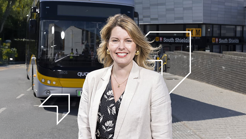 Kim McGuiness stood next to bus