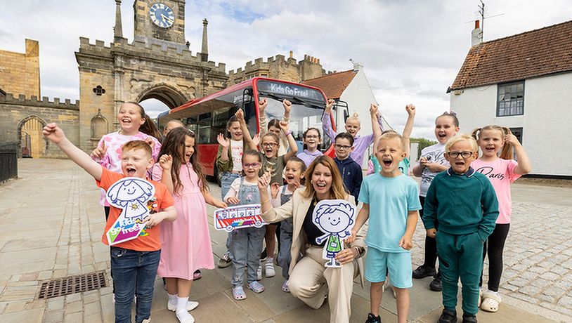 Group of happy children next to bus
