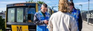 Two customer service advisers check tickets and issue Metro Penalty Fares